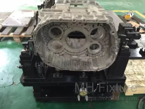 Industrial hydraulic workholding solution designed for Sinotruk gearbox intermediate housing machining on a vertical machining center.
