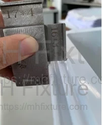 Action 2: Vertical Check - Placing gauge upright to verify liner edge width
